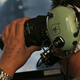In this March 22, 2014, file photo, Flight Officer Jack Chen uses binoculars at an observers window on a Royal Australian Air Force P-3 Orion during the search for missing Malaysia Airlines Flight MH370 in Southern Indian Ocean, Australia. (AP Photo/Rob Griffith, File)